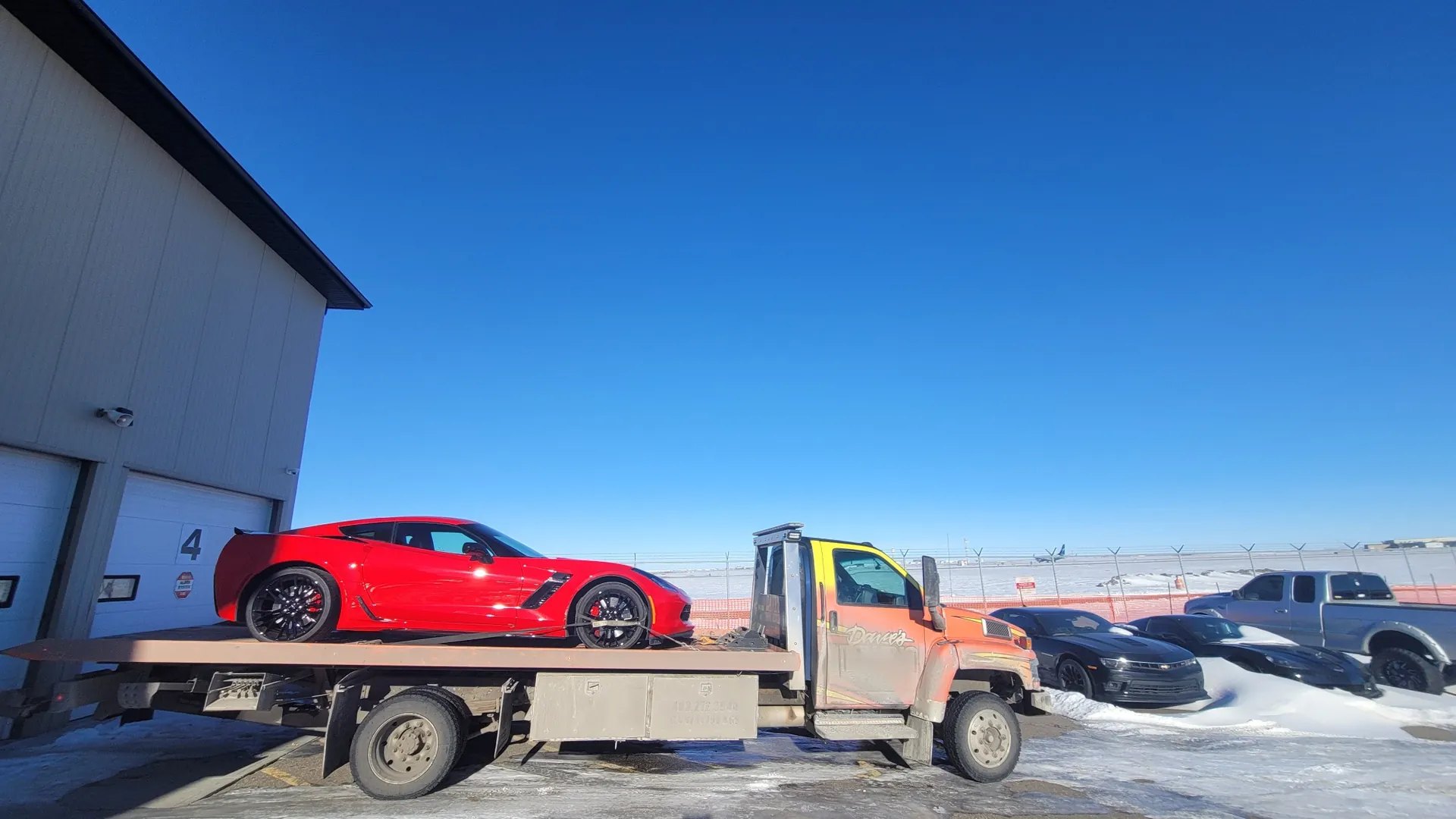 Red Corvette transport in winter – Calgary